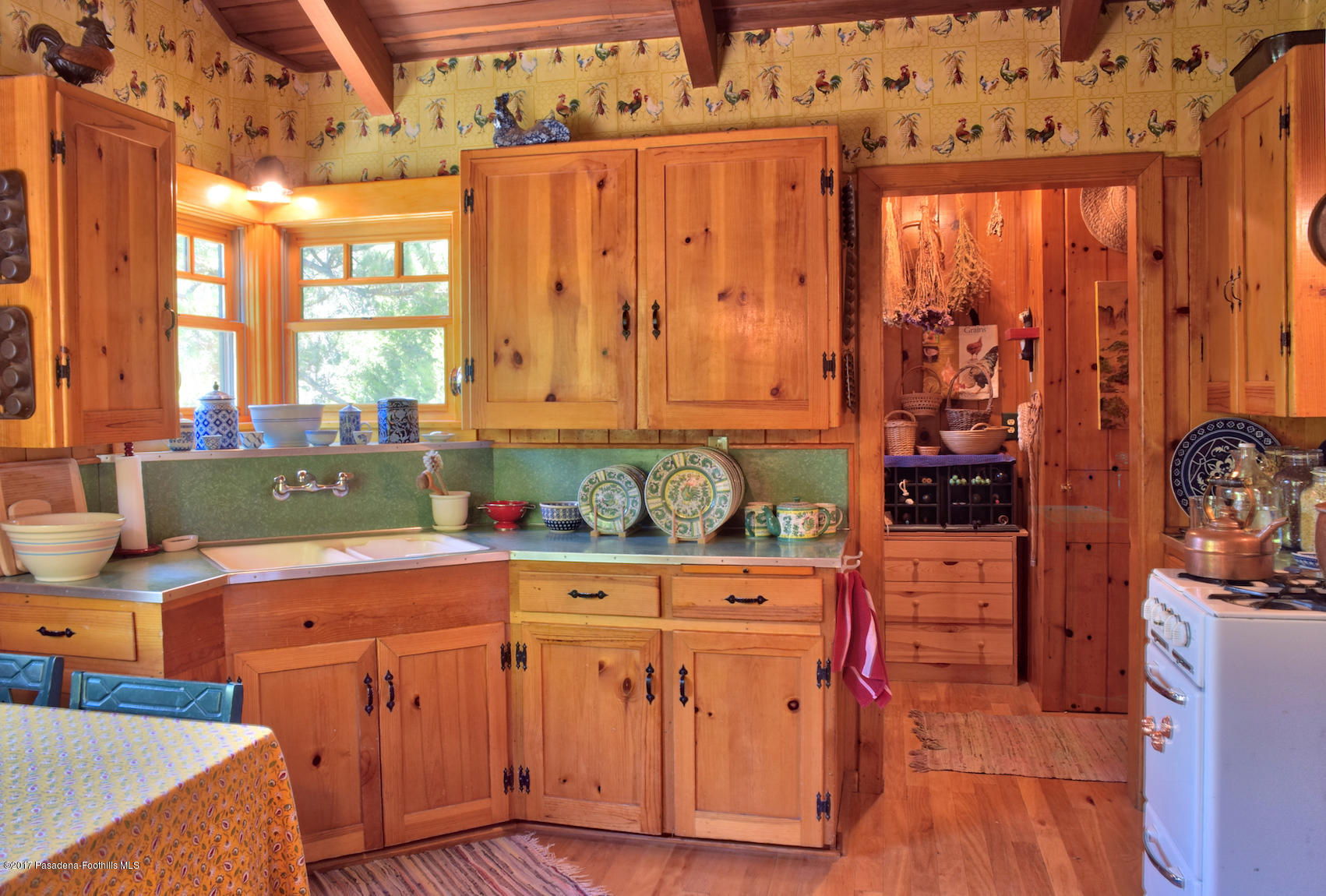 53225 Tollgate Road Idyllwild, CA 92549 - Photo 6 of 24 a room with a window wooden cabinet and table