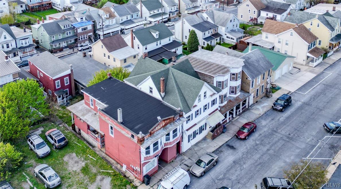 an aerial view of a house with a yard