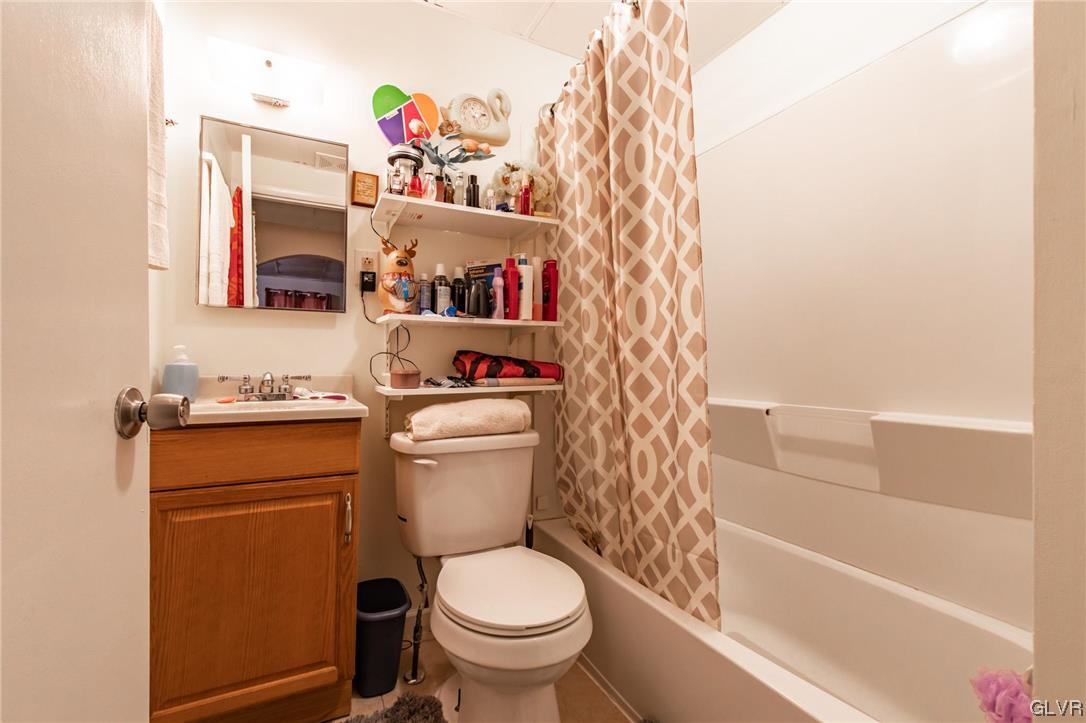 214 West Ridge Street Lansford, PA 18232 - Photo 10 of 26 a bathroom with a toilet and a shower curtain