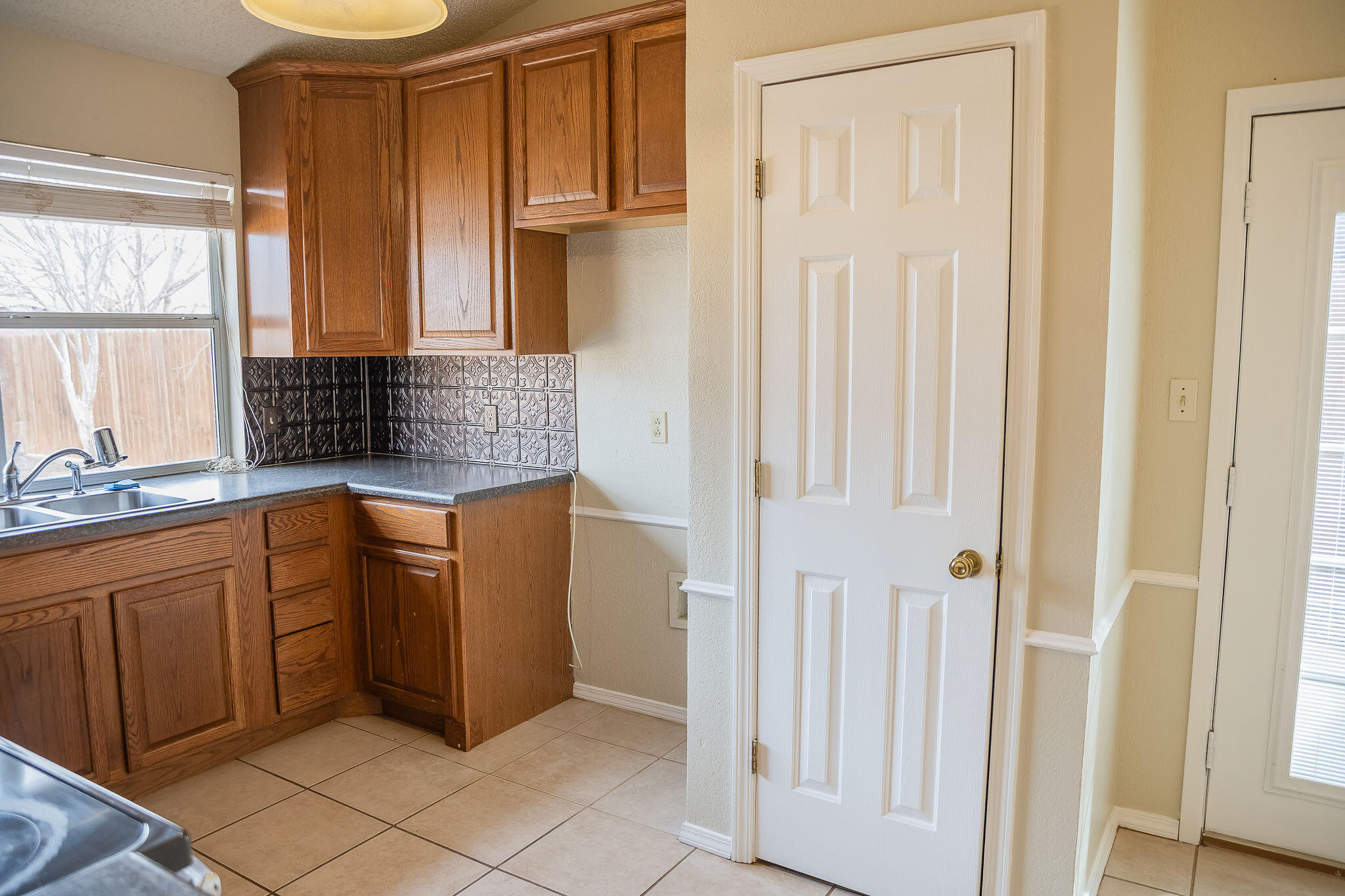 2120 93rd Street Lubbock, TX 79423 - Photo 12 of 32 a kitchen with granite countertop a sink and a refrigerator