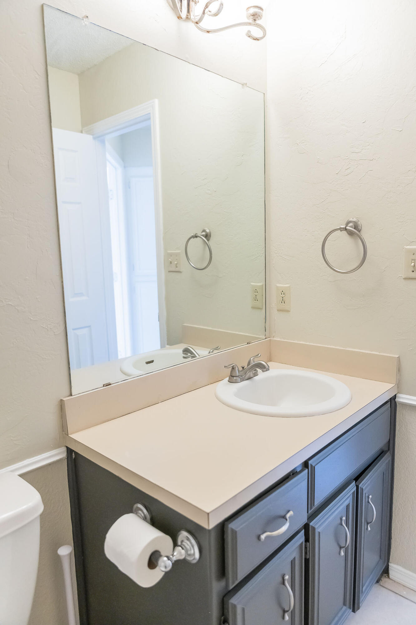 2120 93rd Street Lubbock, TX 79423 - Photo 21 of 32 a bathroom with a sink and a mirror