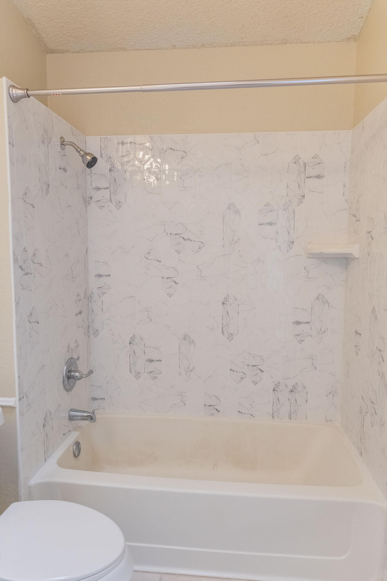 2120 93rd Street Lubbock, TX 79423 - Photo 22 of 32 a bathroom with a shower and a toilet