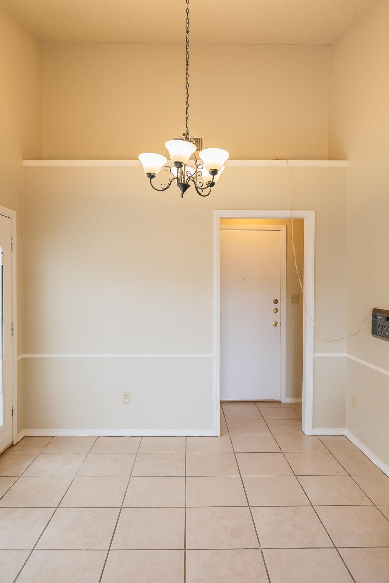 2120 93rd Street Lubbock, TX 79423 - Photo 26 of 32 a view of a livingroom with a chandelier fan and kitchen view