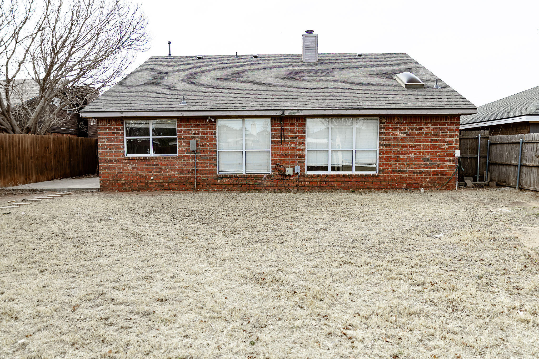 2120 93rd Street Lubbock, TX 79423 - Photo 29 of 32 a front view of a house with a yard
