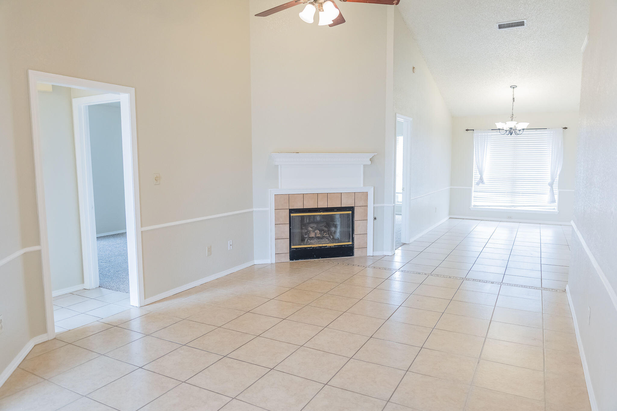 2120 93rd Street Lubbock, TX 79423 - Photo 4 of 32 an empty room with fireplace and windows