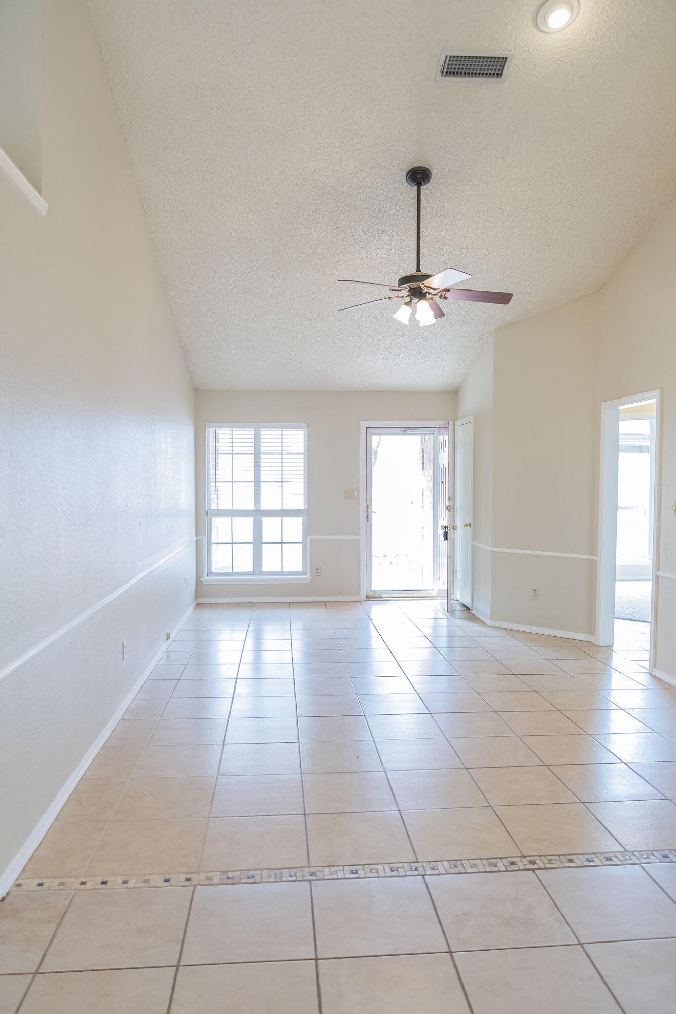 2120 93rd Street Lubbock, TX 79423 - Photo 5 of 32 a view of an empty room with a window