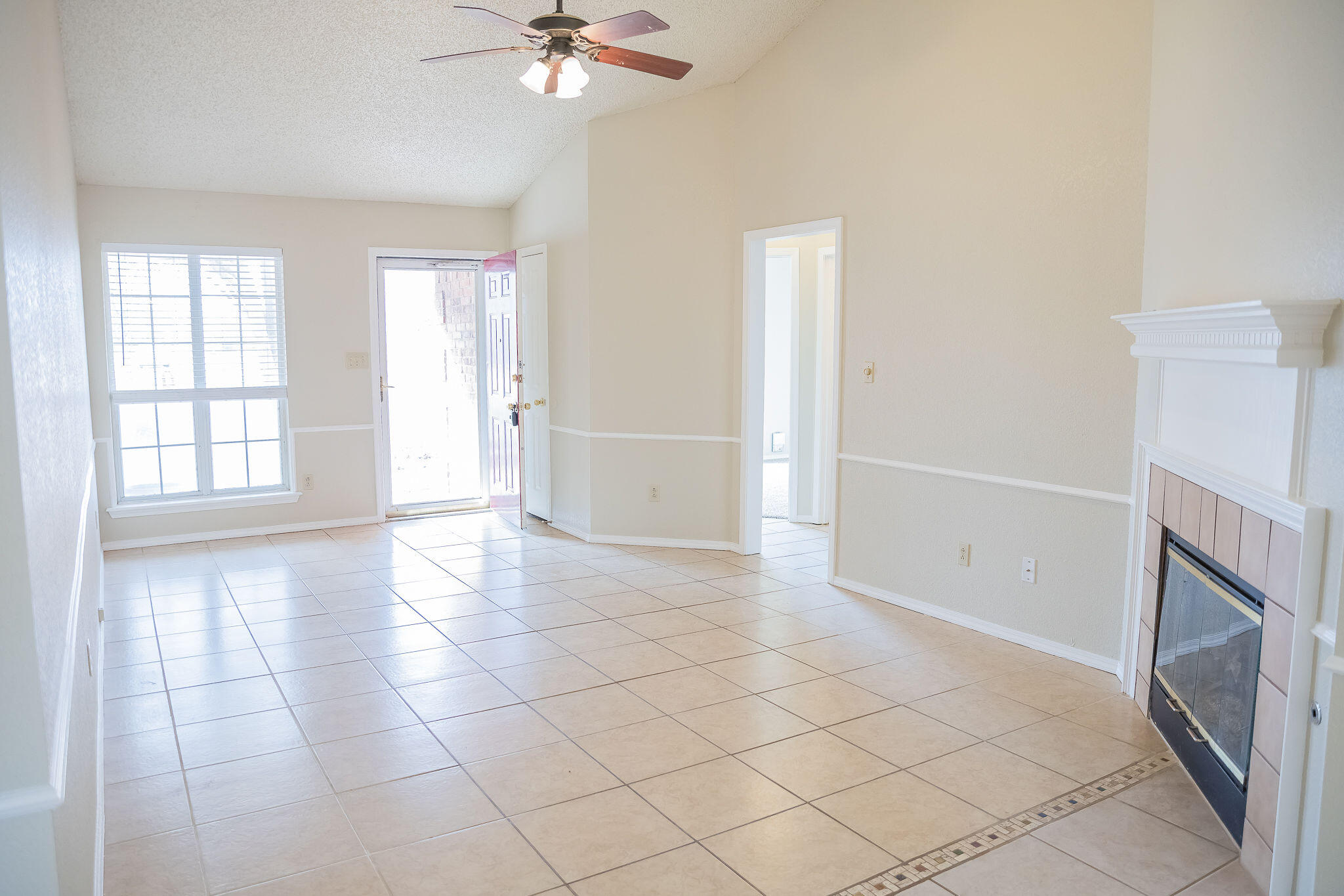 2120 93rd Street Lubbock, TX 79423 - Photo 6 of 32 a view of an empty room with a fireplace