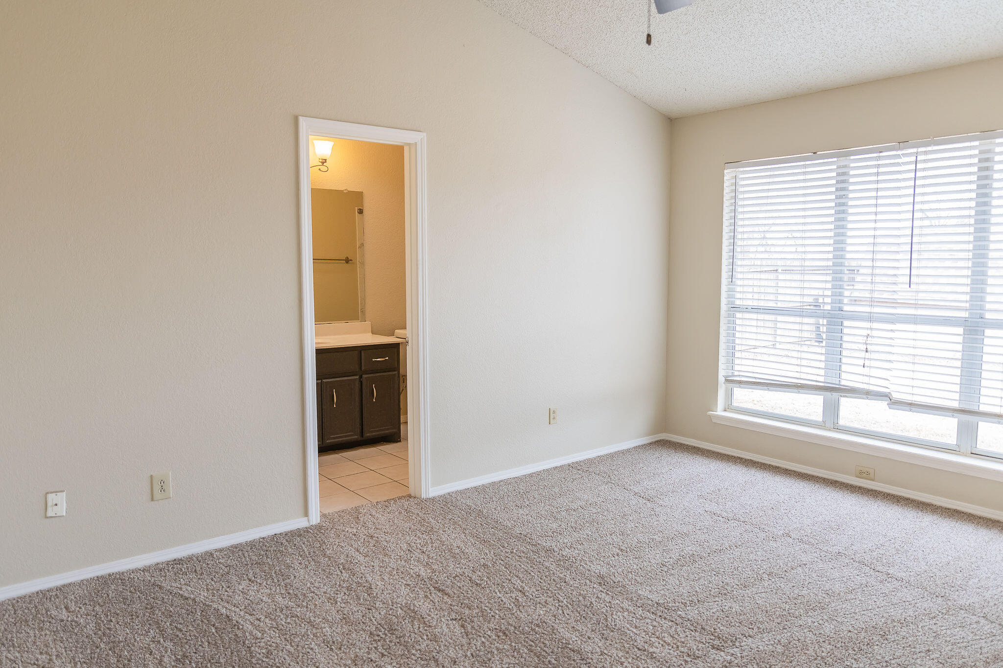 2120 93rd Street Lubbock, TX 79423 - Photo 8 of 32 an empty room with a natural light