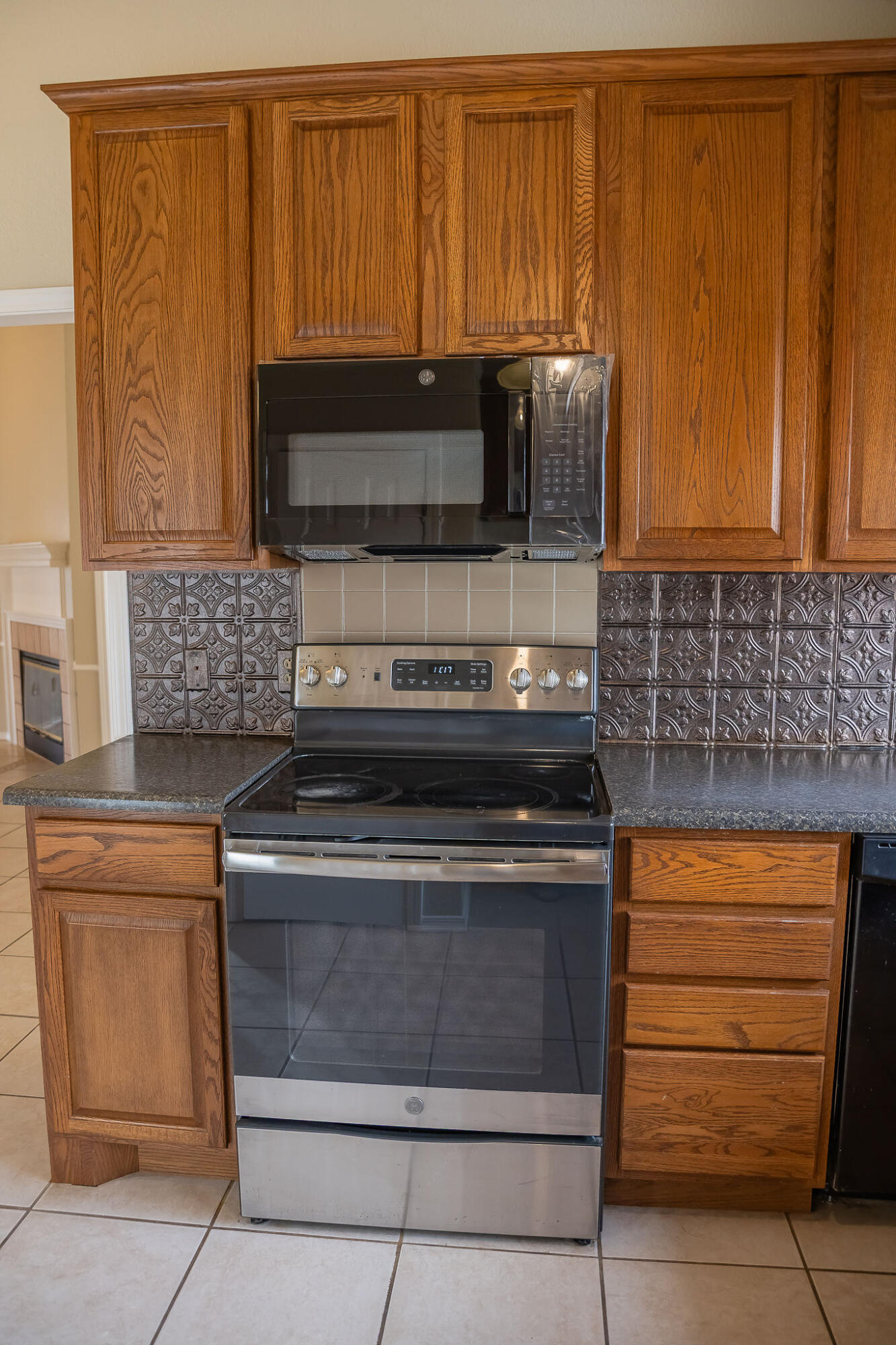 2120 93rd Street Lubbock, TX 79423 - Photo 9 of 32 a kitchen with granite countertop cabinets and steel stainless steel appliances