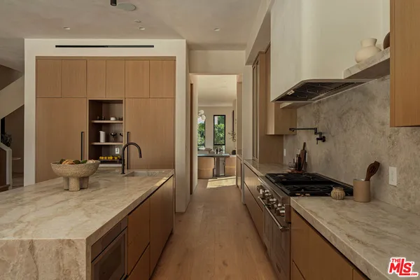 a kitchen with a sink stove and refrigerator