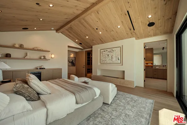 a bedroom with a bed and a large mirror