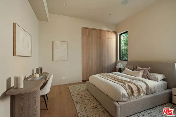 a bedroom with a bed and a table