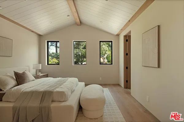 a bedroom with bed and window