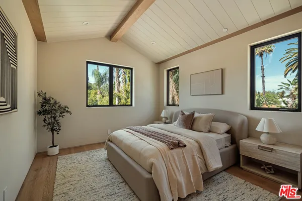 a bedroom with a bed and a couch