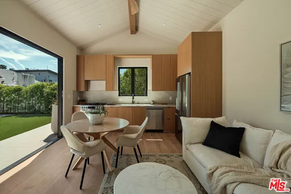 a living room with furniture a window and a table