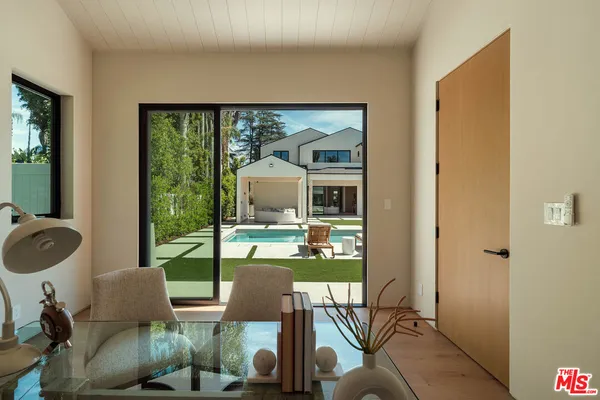 a living room with furniture and a floor to ceiling window