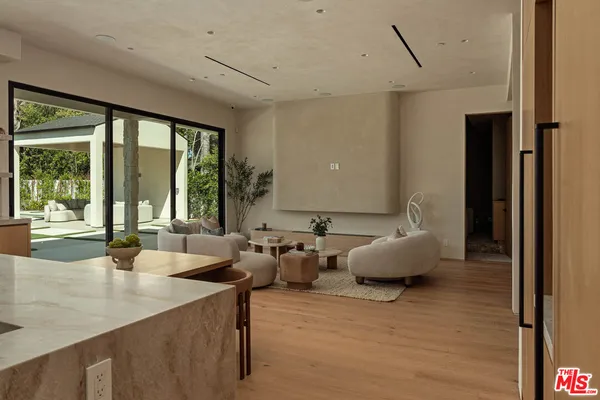a living room with furniture and large windows