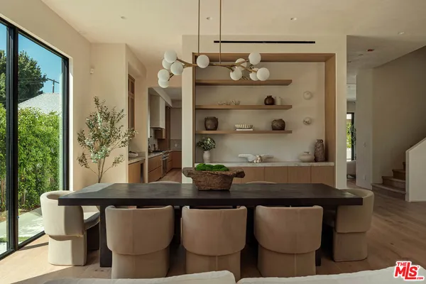 a kitchen with a table chairs and window
