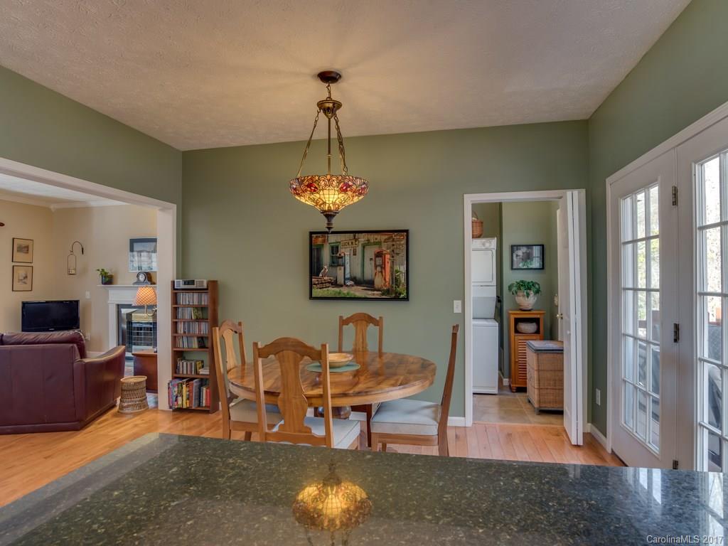 2129 Locust Grove Road, Unit 8 Hendersonville, NC 28792 - Photo 8 of 24 a living room with furniture and a chandelier