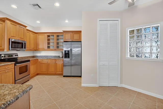 a kitchen with a sink stove and white cabinets