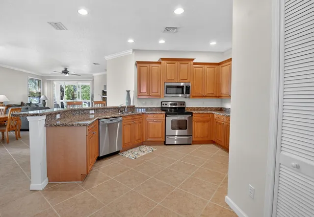 a kitchen with stainless steel appliances granite countertop a sink and cabinets