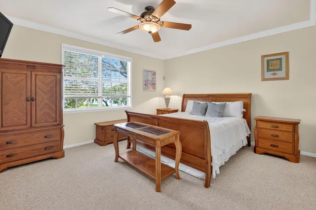 a bedroom with a bed dresser and a window