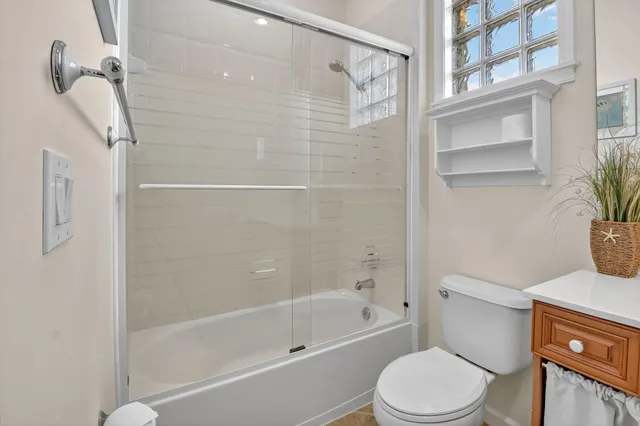 a bedroom with a bed and a refrigerator