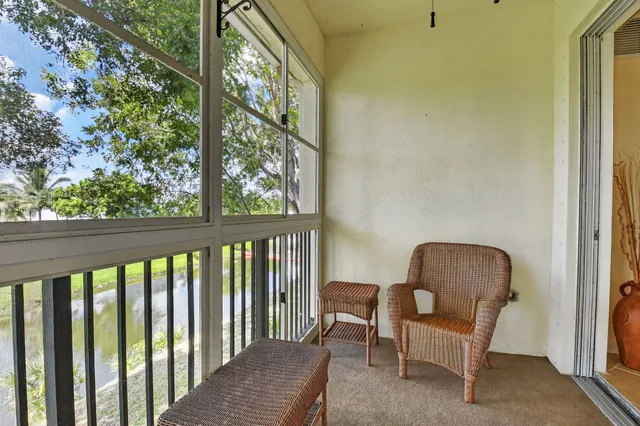 a balcony view with a large window and sitting space