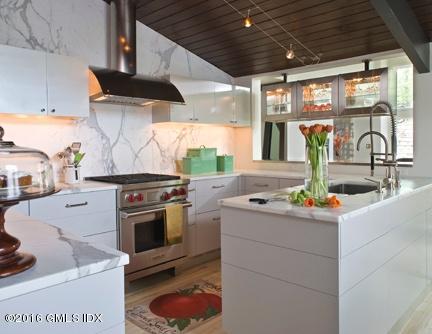 a kitchen with stainless steel appliances granite countertop a sink and a stove