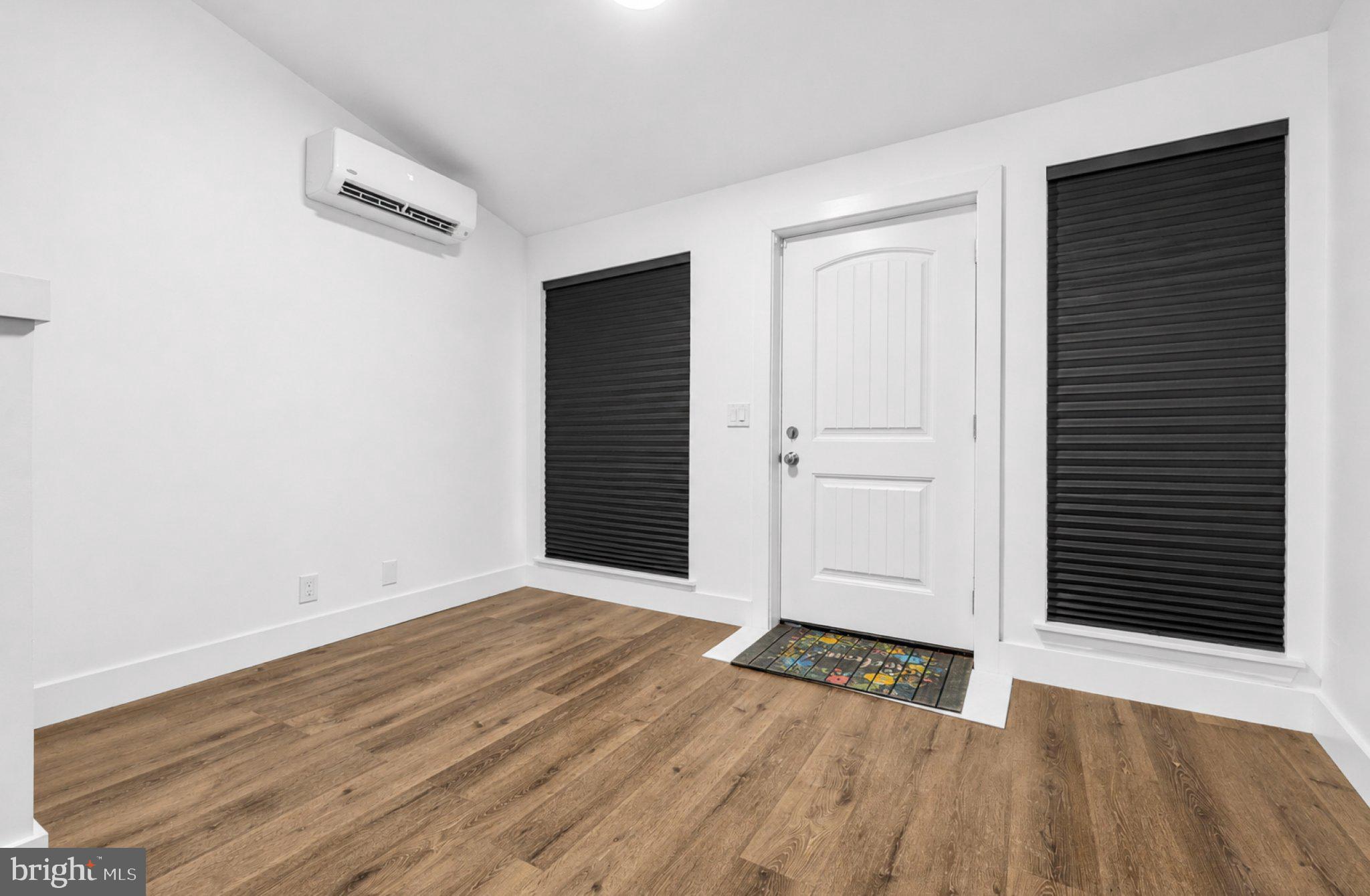 2801 Round Road Baltimore, MD 21225 - Photo 8 of 29 an empty room with wooden floor and windows
