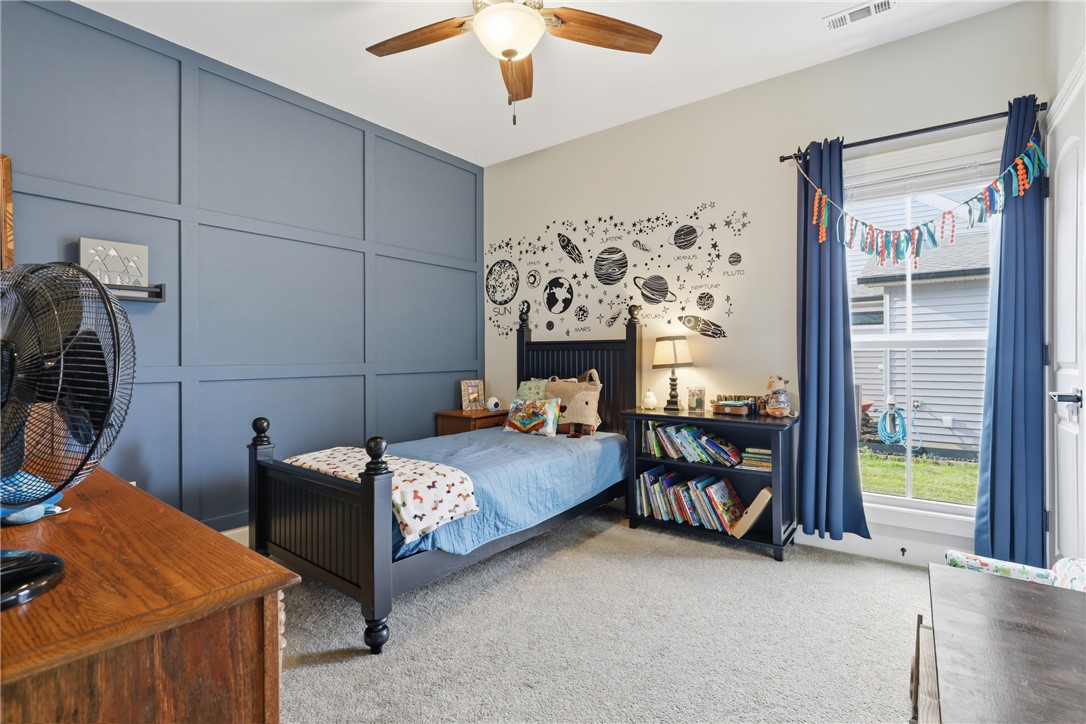 127 West Stewart Street Pelzer, SC 29669 - Photo 13 of 23 This cozy bedroom features a stylish accent wall, creating a vibrant and inviting atmosphere.