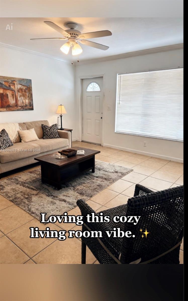 412 Southwest 10th Street, Unit 12 Hallandale Beach, FL 33009 - Photo 2 of 11 a living room with a couch