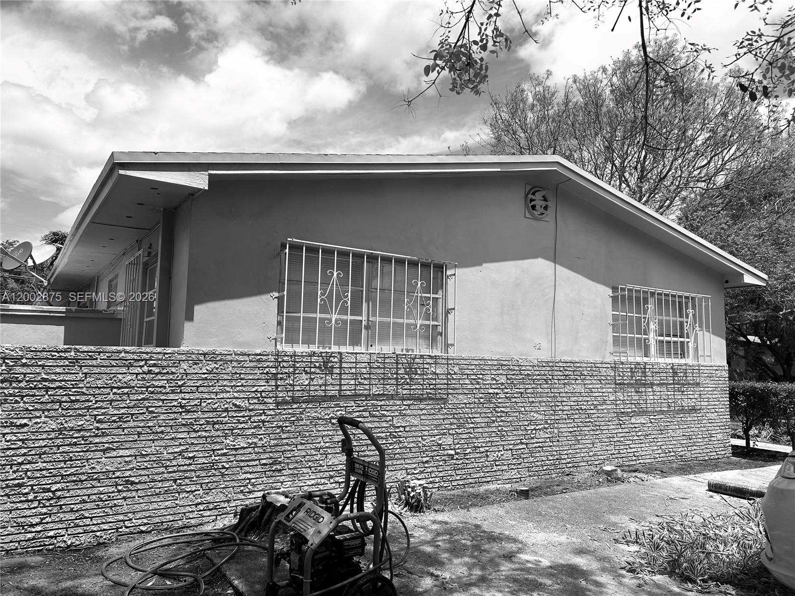 412 Southwest 10th Street, Unit 12 Hallandale Beach, FL 33009 - Photo 3 of 11 a front view of a house with parking area