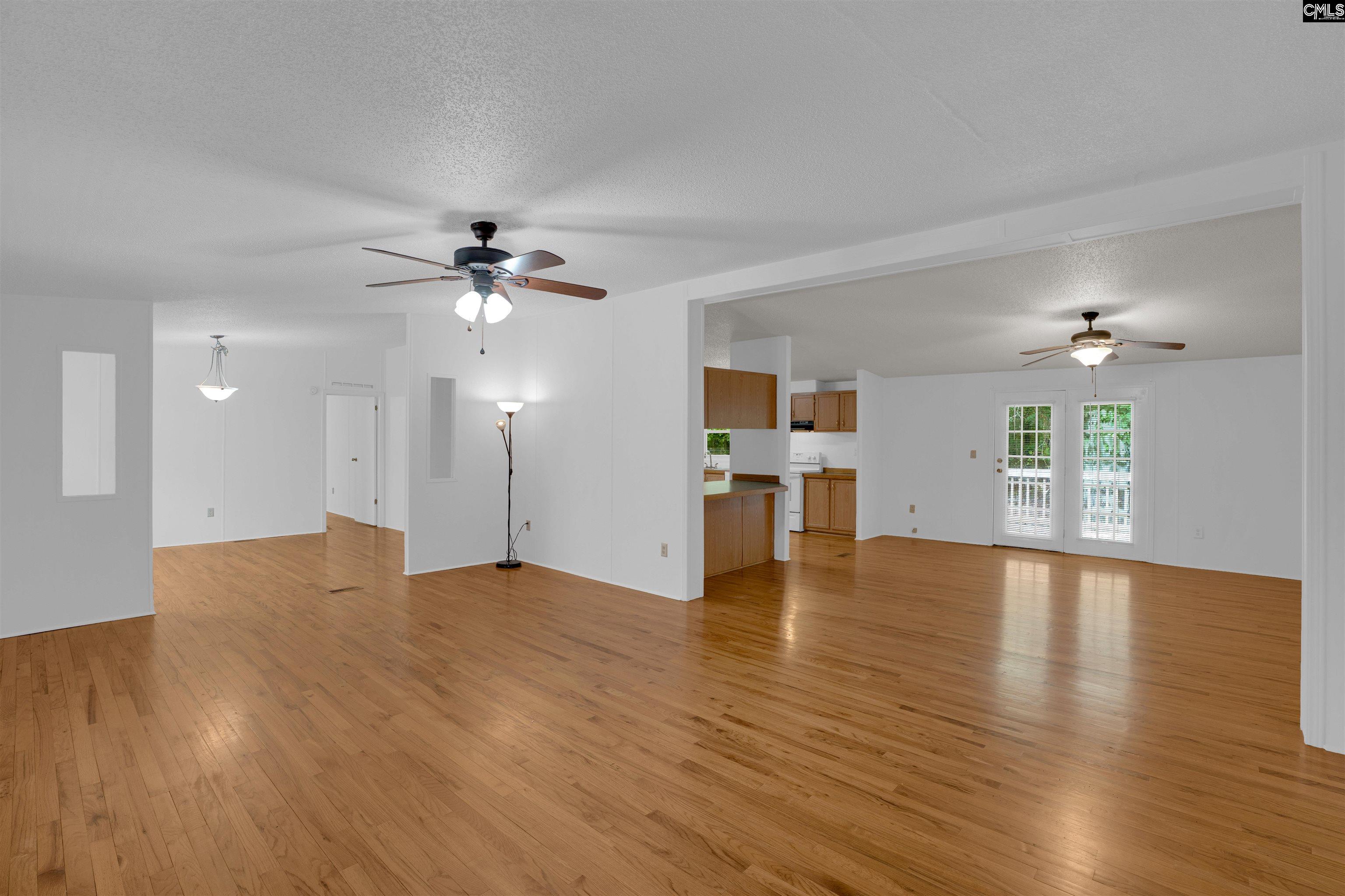 304 Cooper Road Blythewood, SC 29016 - Photo 6 of 29 a view of an empty room with a window and wooden floor