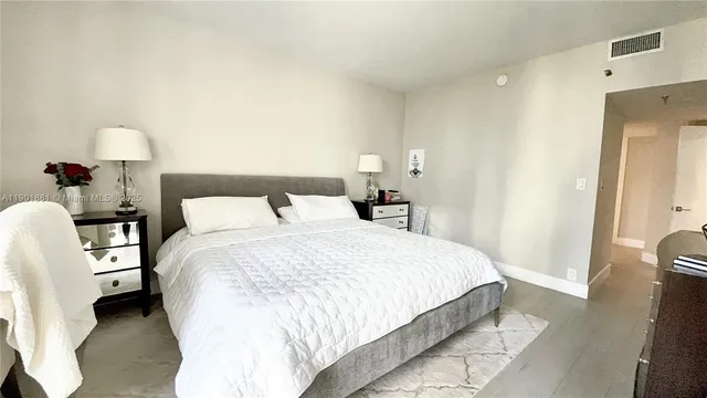 a bedroom with a bed and a lamp