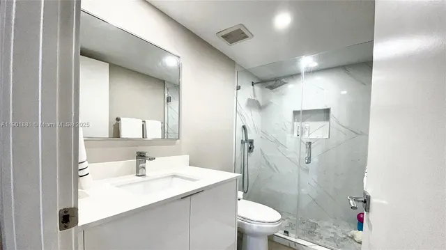 a bathroom with a sink toilet and shower