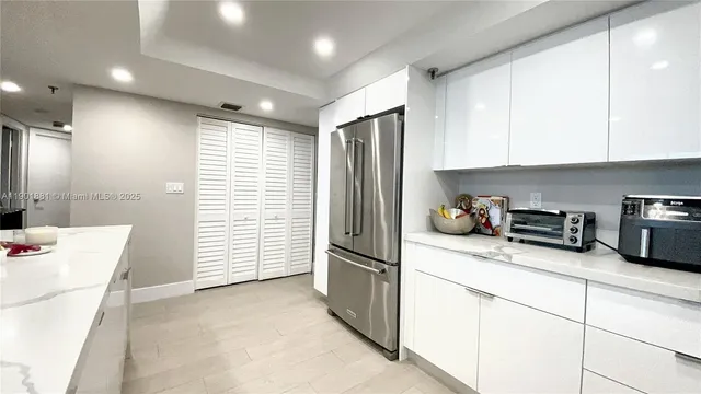 a kitchen with stainless steel appliances granite countertop a refrigerator sink and cabinets