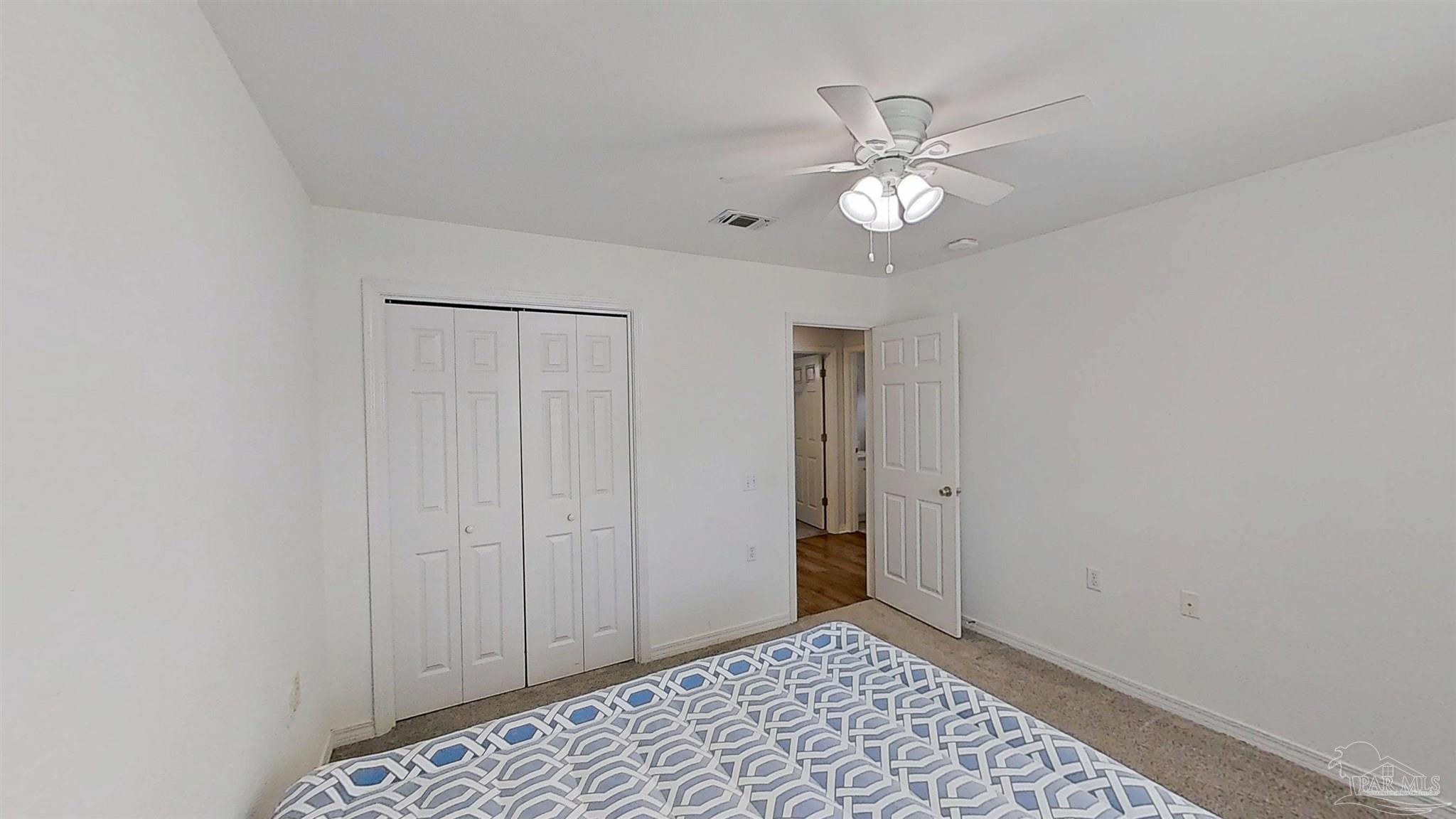 1039 Brownfield Road Pensacola, FL 32526 - Photo 11 of 14 a view of an empty room with a ceiling fan