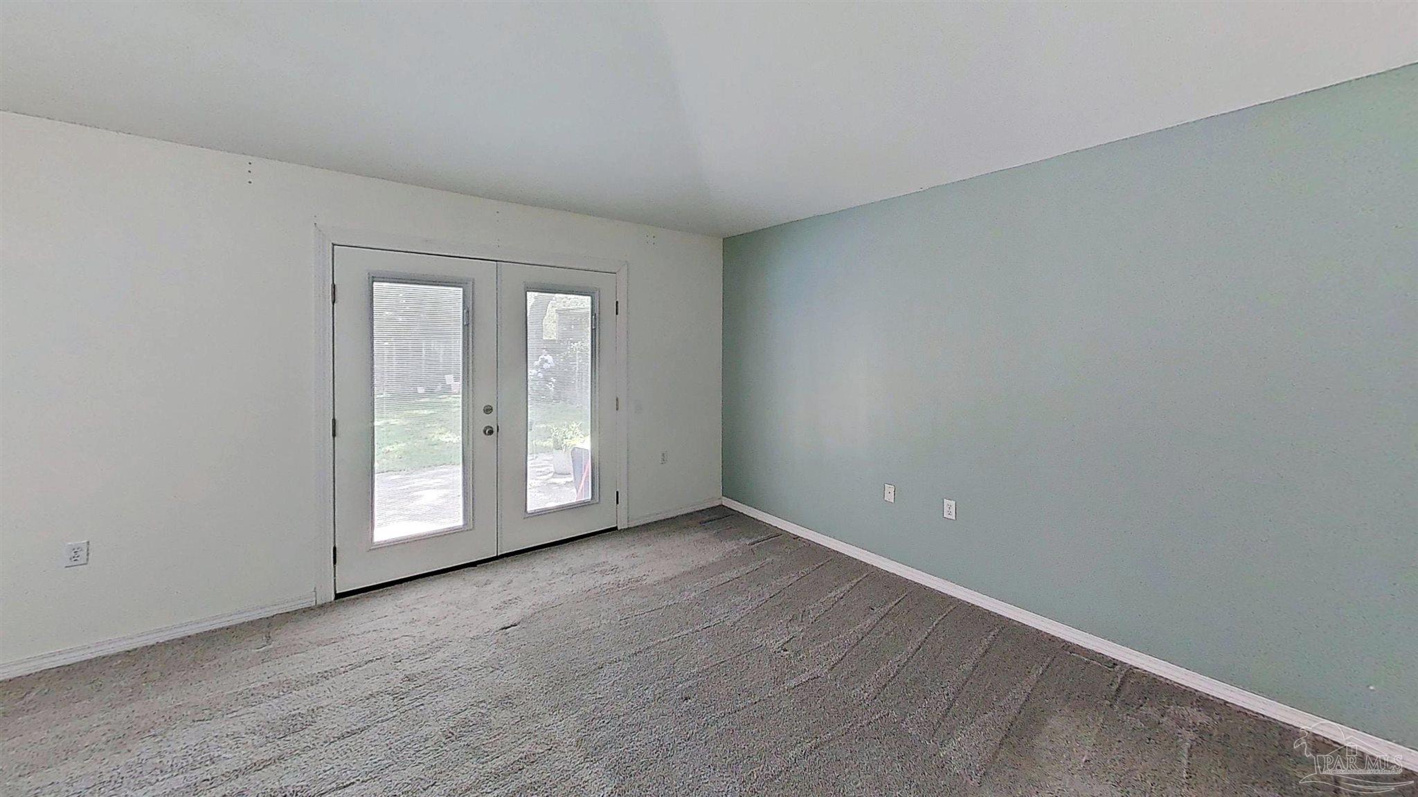 1039 Brownfield Road Pensacola, FL 32526 - Photo 6 of 14 a view of an empty room with wooden floor and a window