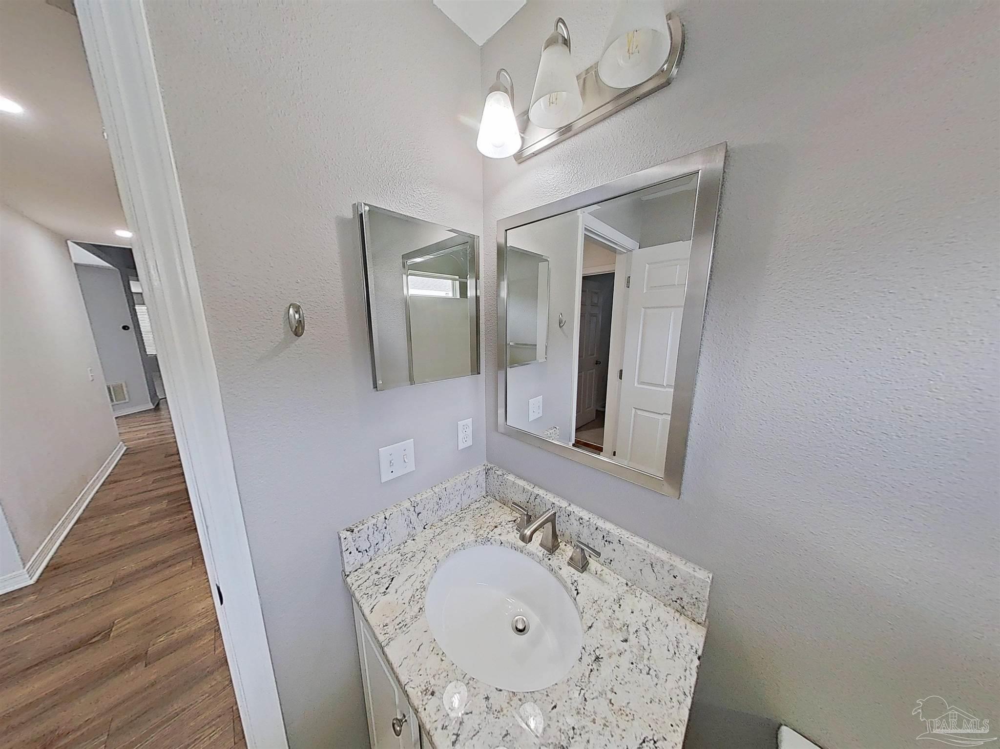 1039 Brownfield Road Pensacola, FL 32526 - Photo 10 of 14 a bathroom with a sink and a mirror