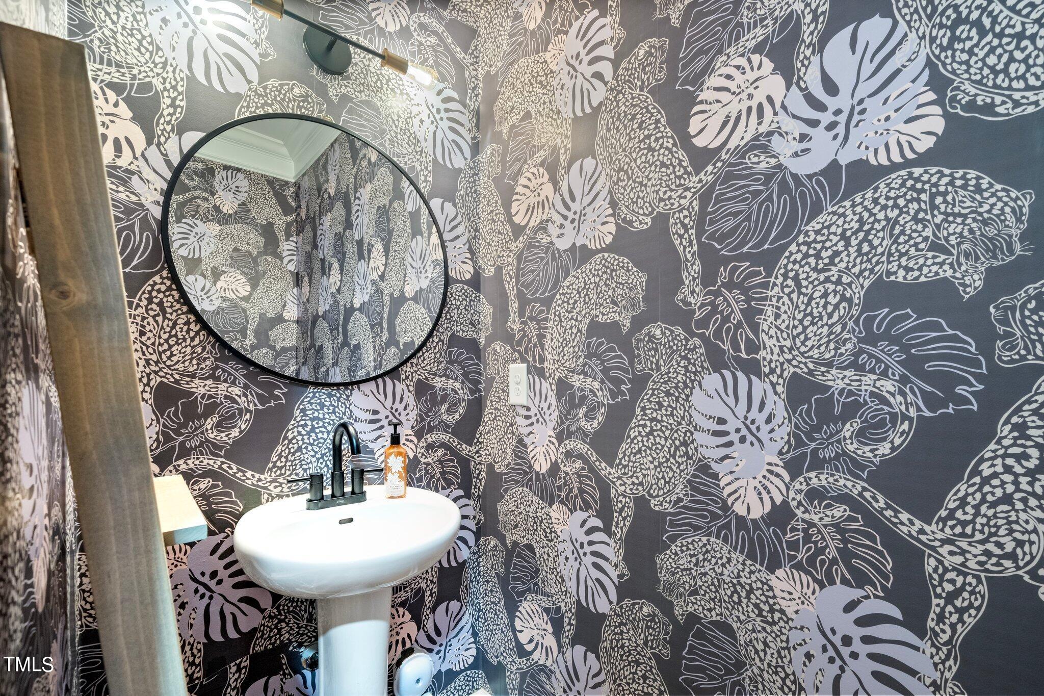 903 Ambergate Station Apex, NC 27502 - Photo 11 of 24 a bathroom with a sink and mirror