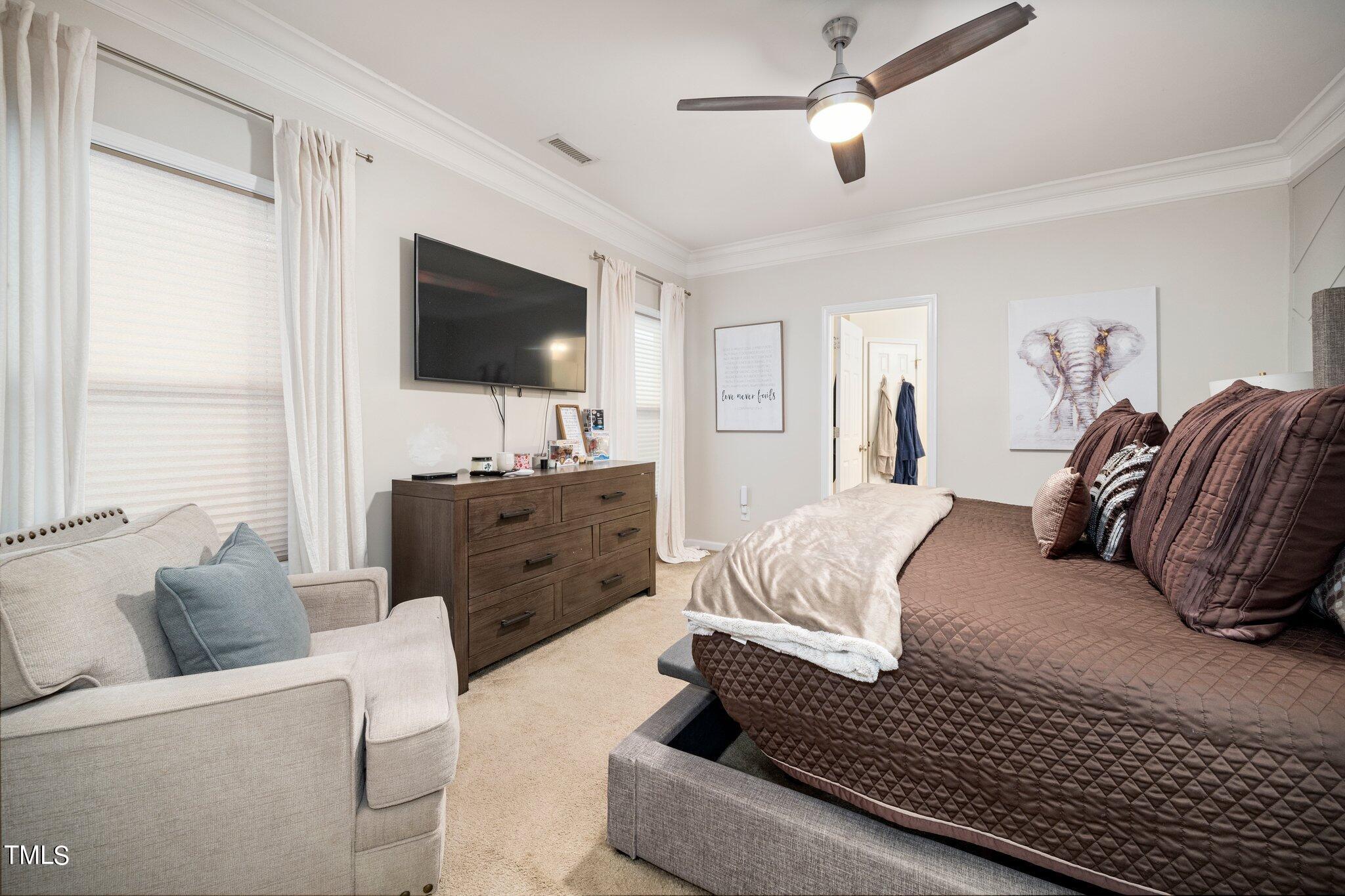 903 Ambergate Station Apex, NC 27502 - Photo 12 of 24 a living room with furniture and a flat screen tv