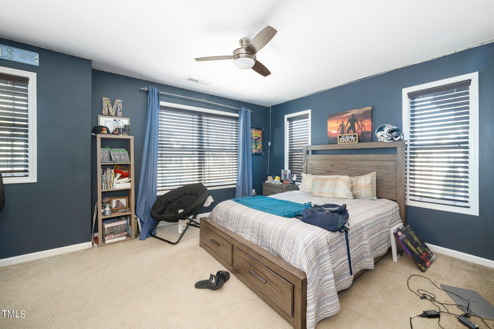903 Ambergate Station Apex, NC 27502 - Photo 14 of 24 a bedroom with a bed and a desk