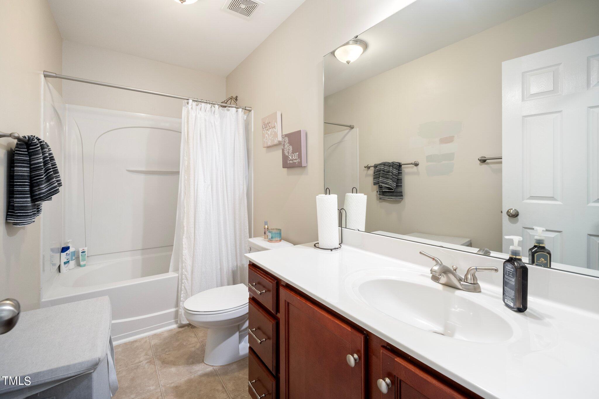 903 Ambergate Station Apex, NC 27502 - Photo 15 of 24 a bathroom with a granite countertop sink toilet and shower