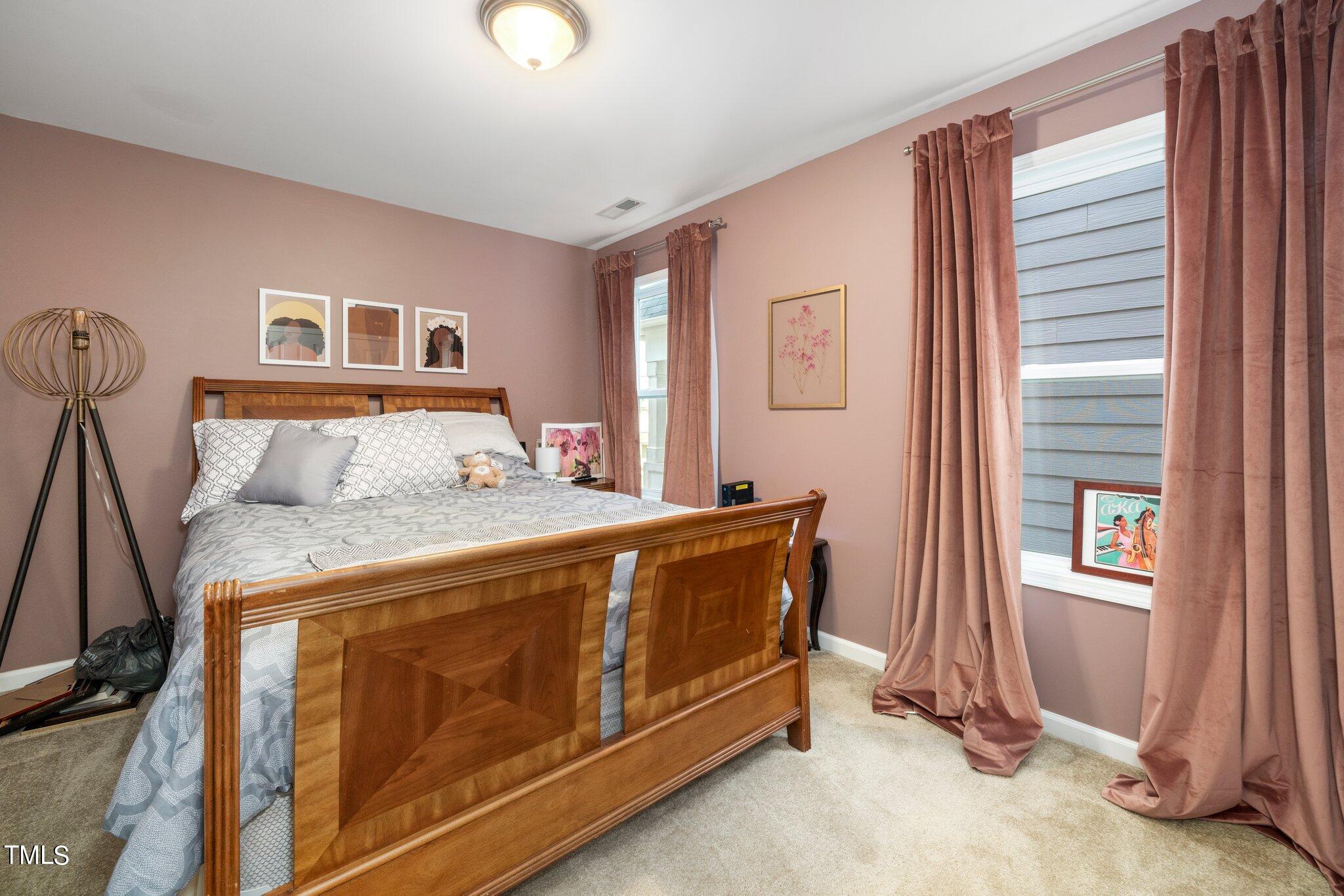 903 Ambergate Station Apex, NC 27502 - Photo 16 of 24 a bedroom with a bed and a window