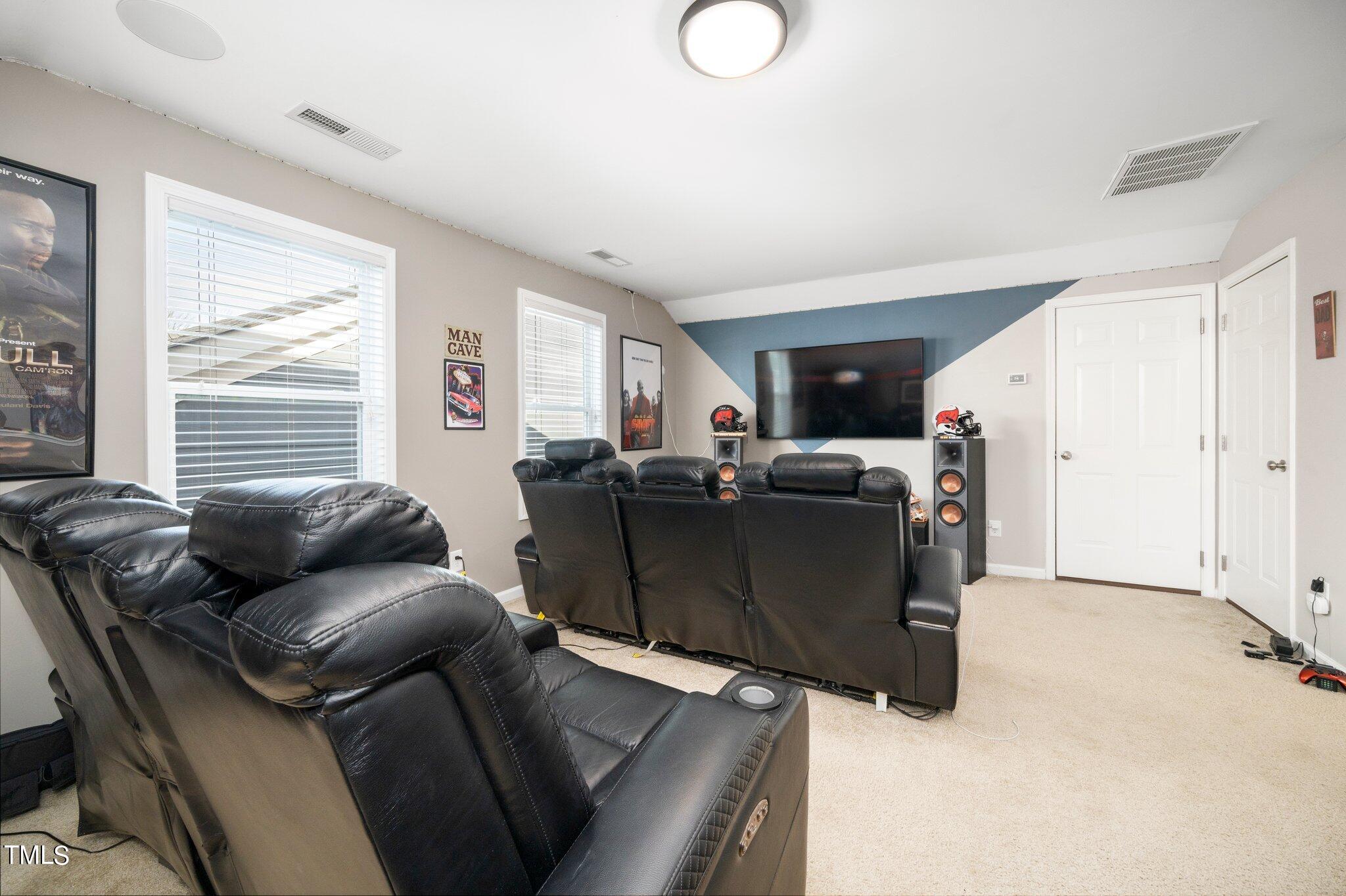 903 Ambergate Station Apex, NC 27502 - Photo 19 of 24 a living room with furniture and a window