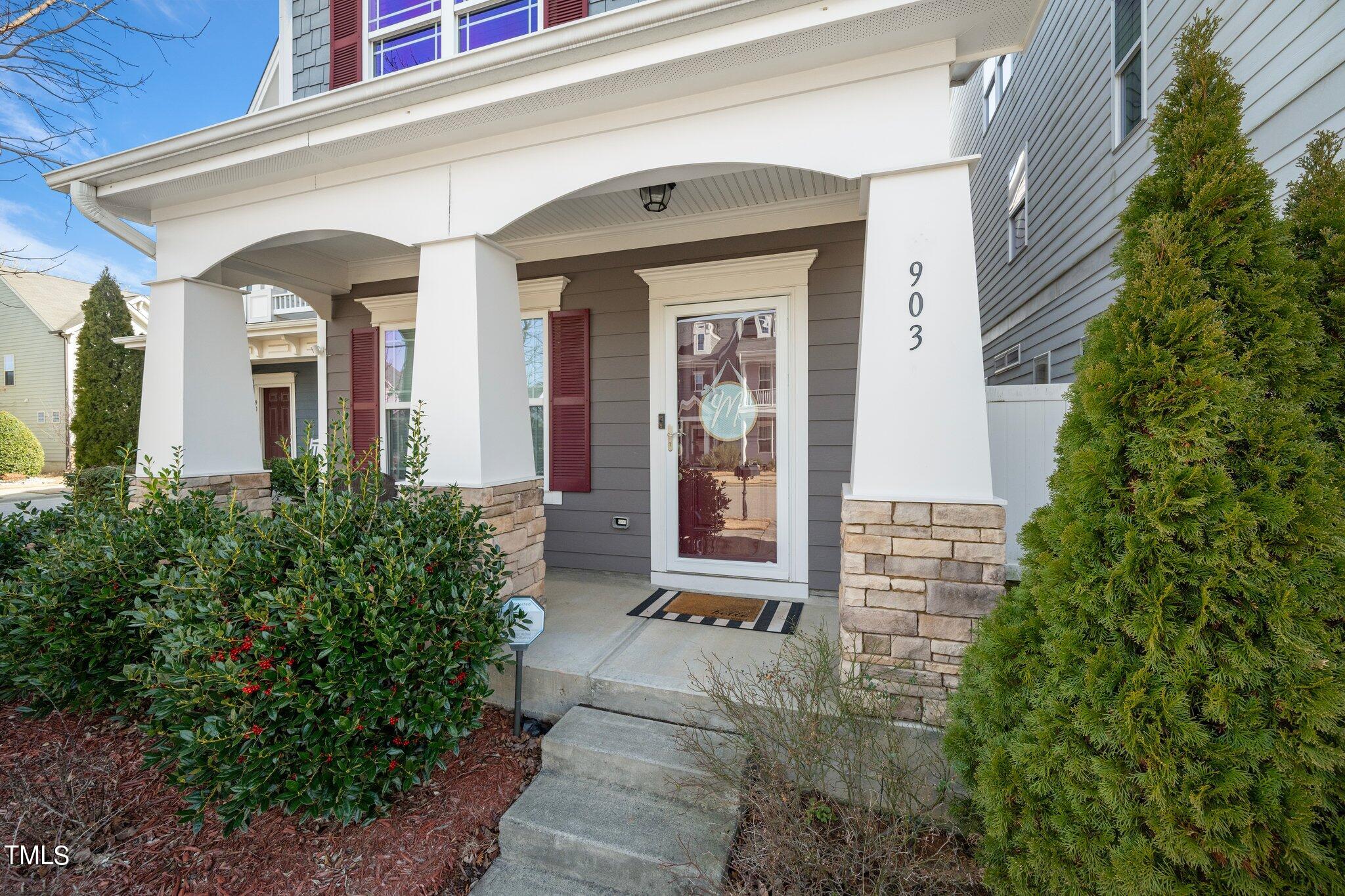 903 Ambergate Station Apex, NC 27502 - Photo 2 of 24 a view of a brick house with potted plants