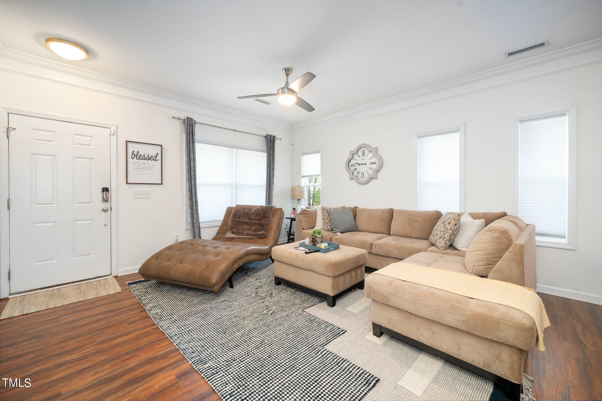 903 Ambergate Station Apex, NC 27502 - Photo 4 of 24 a living room with furniture and a wooden floor