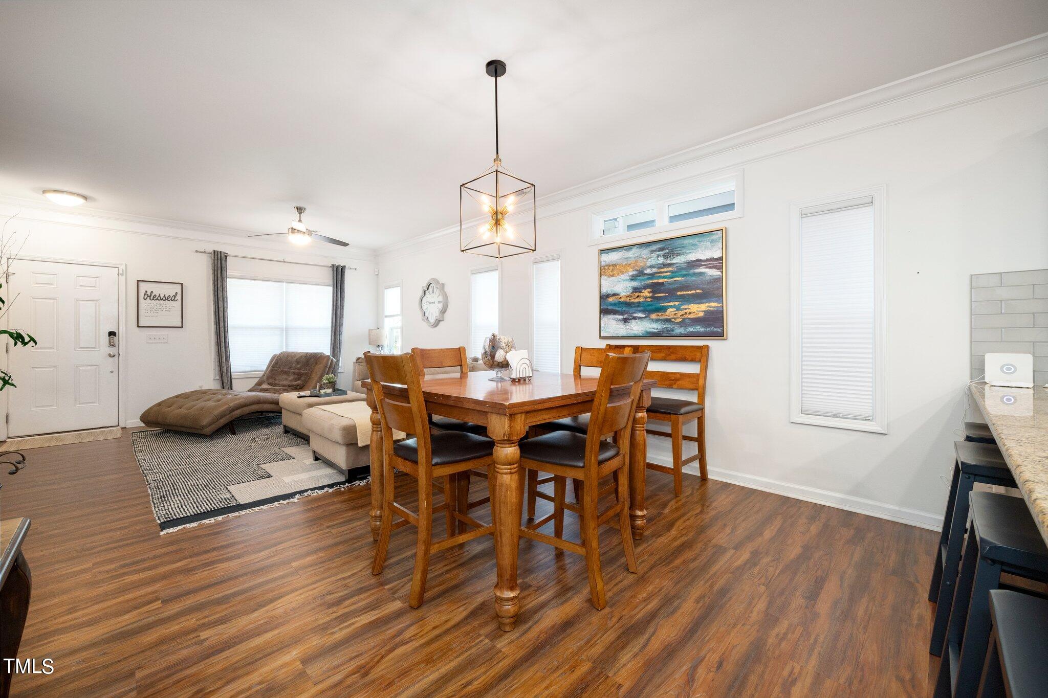 903 Ambergate Station Apex, NC 27502 - Photo 6 of 24 a view of a dining room with furniture window and wooden floor