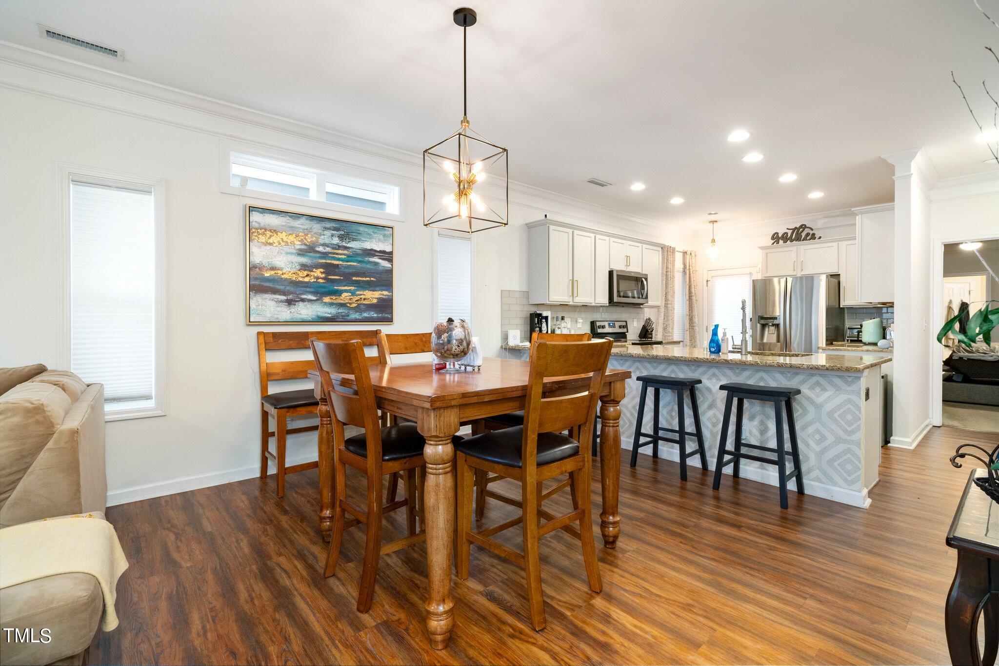903 Ambergate Station Apex, NC 27502 - Photo 7 of 24 a view of a dining room with furniture window and wooden floor